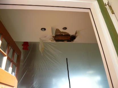 Ceiling Leak: Section of water damage ceiling removed to locate source of leak